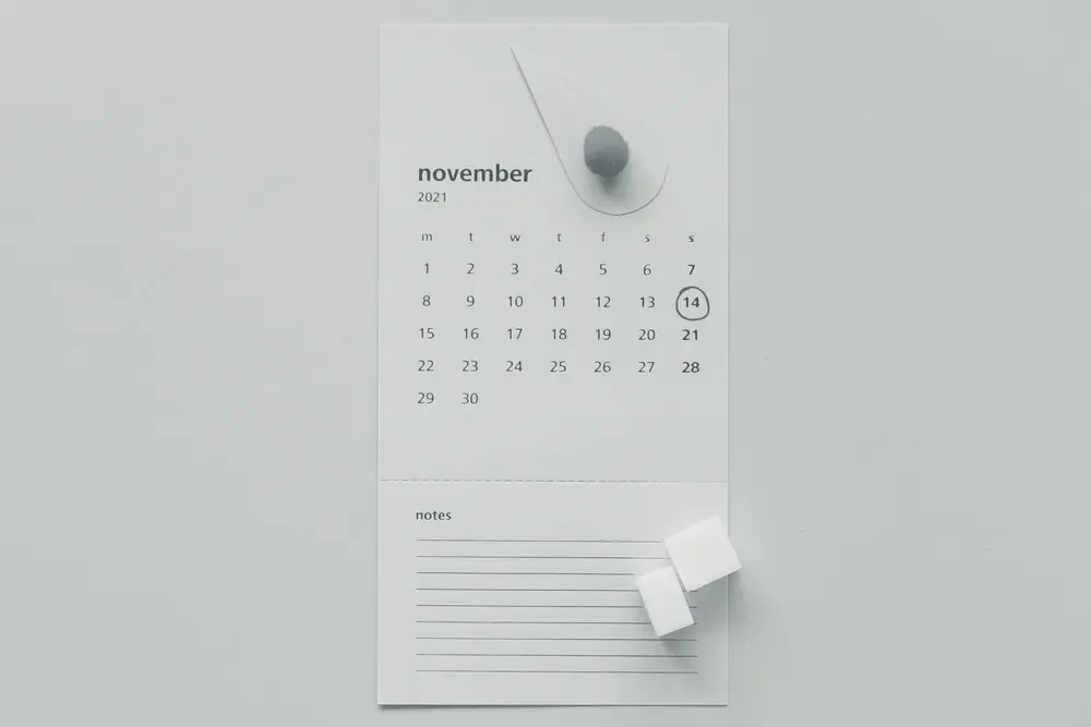 A wall calendar with one day circled and a decorative drop-shaped cutout on the page.